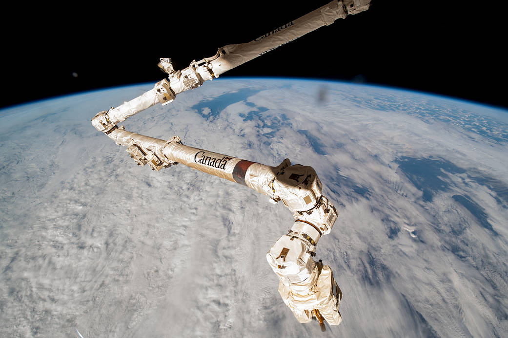 The Canadarm2 robotic arm above the clouds