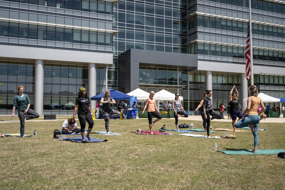 Marshall team members participate in a free yoga class on the south lawn of Building 4221 during the center’s Earth Day celebration. 