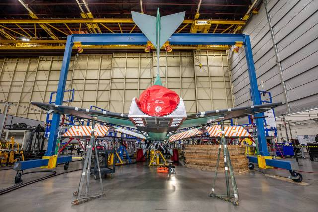 Back view of the X-59 tail with a red cover over the engine nozzle. The red plug or covering protects the engine by creating a barrier so that foreign objects cannot enter the engine or engine inlet.