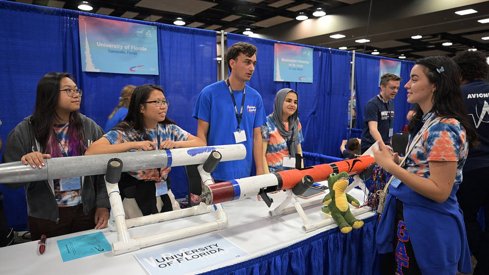 Team members from the University of Florida discuss their rocket during the Rocket Fair in Huntsville on April 14, the day before the Student Launch competition. 