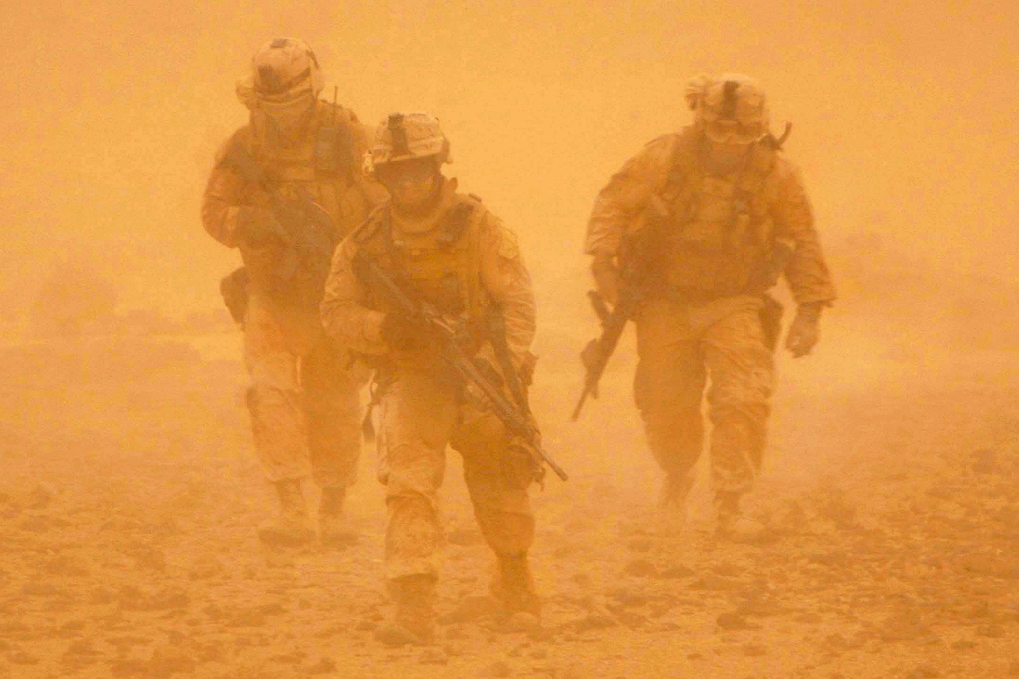 U.S. Marines make their way back to their vehicles in the middle of a sandstorm after patrolling a nearby mountain ridge in Bakwa, Farah province, Afghanistan, May 3, 2009. 