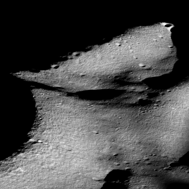 Oblique view of the rim of Shackleton crater (on the left) and the Shackleton - de Gerlache ridge that runs from middle left to upper right, seen in an image captured by the Lunar Reconnaissance Orbiter Camera. The south pole is near the small, sharp, bright crater on the rim of Shackleton (left side of the image about 25% up from the bottom). Ridgeline is about 14 kilometers long