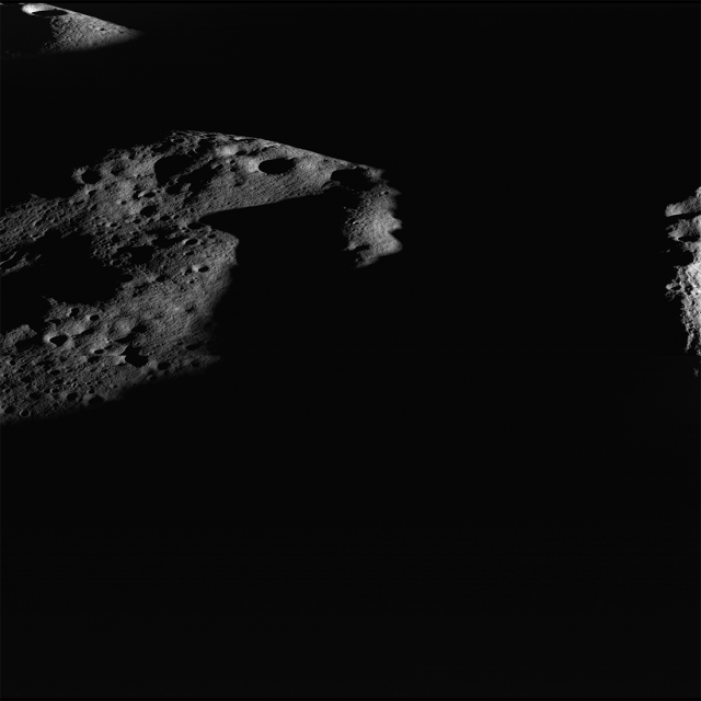 Darkness surrounds illuminated peaks near Shackleton crater (rim crest at right), seen in an image captured by the Lunar Reconnaissance Orbiter Camera. As lunar days and seasons progress, darkness creeps along this elevated ridge near the south pole. Image width is 15 kilometers.