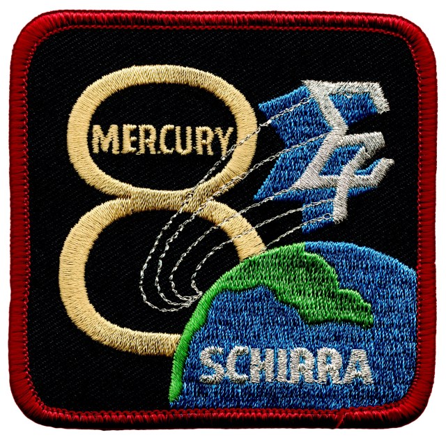 Mission patch for the Mercury-Atlas 8 mission. Words on the patch include Schirra and a sigma symbol with a 7
