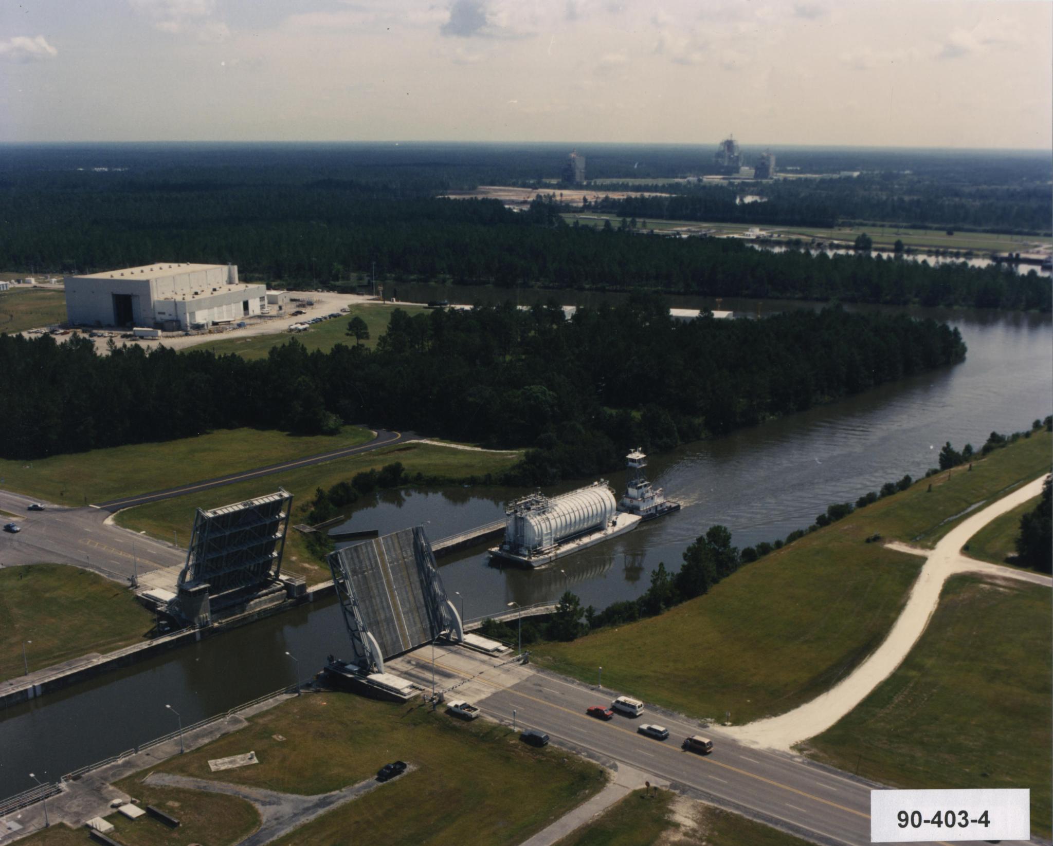 A hydrogen barge working its way through the bridge and lock system at Stennis Space Center.