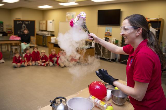 NASA engineer Megan Martinez conducts a cryogenic demonstration for students at INFINITY Science Center