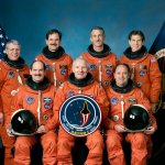 Picture of the STS-35 crew portrait of astronauts in their orange flight suits.
