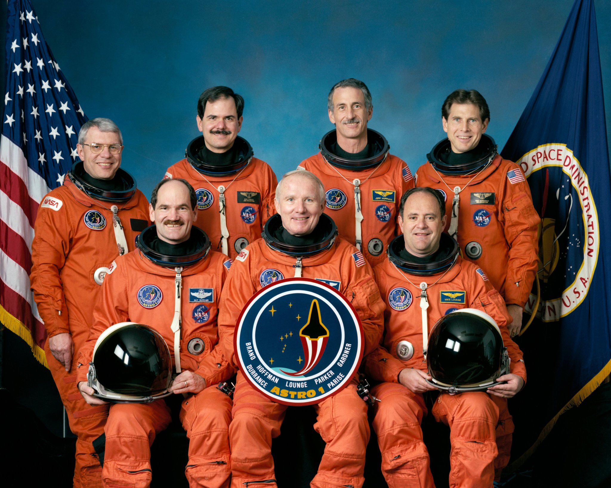 Picture of the STS-35 crew portrait of astronauts in their orange flight suits.