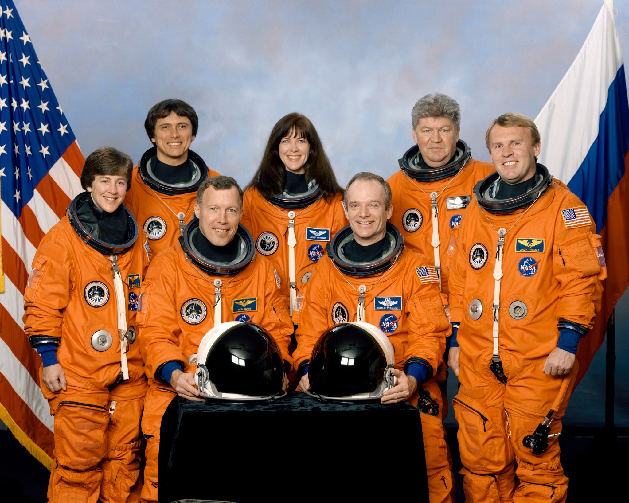 STS-91 crew portrait with the crewmembers pictured in their orange Advanced Crew Escape Suits.