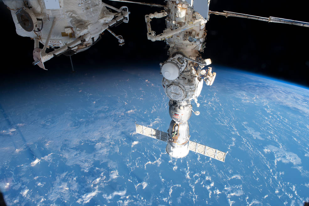 Cosmonauts Sergey Prokopyev and Dmitri Petelin work outside the space station to deploy and activate a radiator on the Nauka science module during a May 12 spacewalk. 