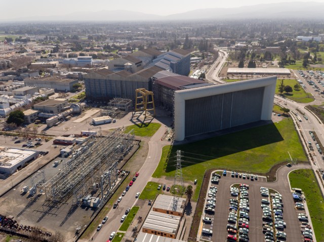 NASA Ames Research Center aerial from the NFAC 80-by-120-foot wind tunnel inlet vanes N221B with Power Substation North N225B, Office Trailers TR35A, TR35, and TR35C in forground looking west across center. The image was taken by Jonas Jonsson and Zachary Roberts, General Engineers with the Ames Aeronautics Projects Office, during a drone flight over the center.