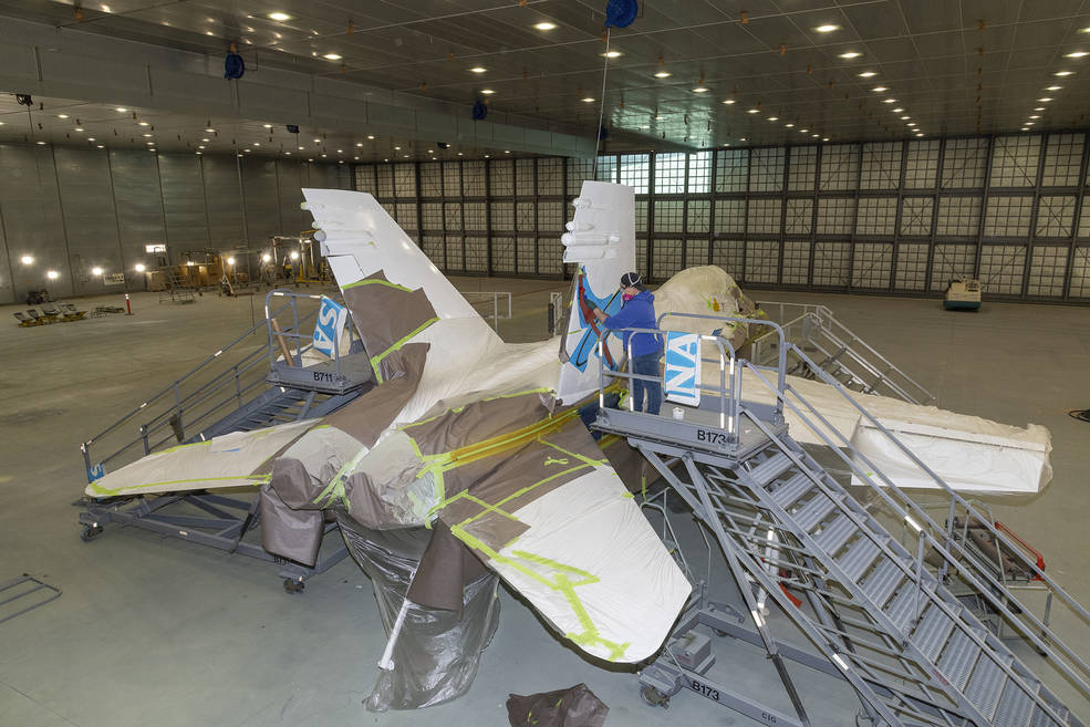 U.S. Air Force Corrosion Control Facility’s Shelby Youngo paints tail art on to NASA 862, which is an F/A-18D based at NASA’s Armstrong Flight Research Center in Edwards, California.