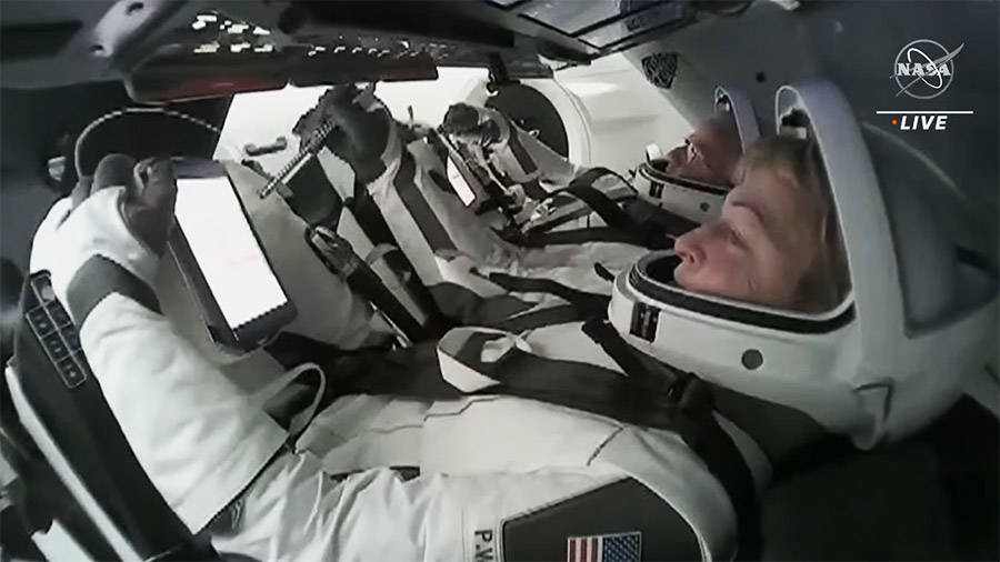 Ax-2 commander Peggy Whitson, foreground, and pilot John Shoffner suited up and seated inside the SpaceX Dragon Freedom spacecraft preparing to undock from the space station on May 30.