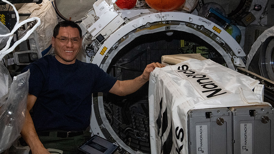 Astronaut Frank Rubio works to install the NanoRacks CubeSat Deployer inside the Kibo laboratory module's airlock on April 20, 2023.