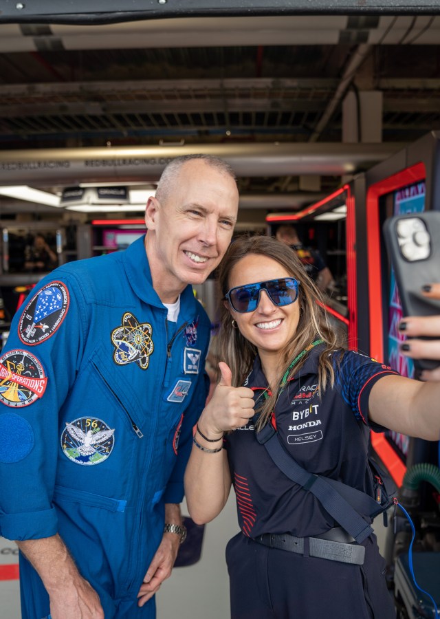 NASA astronaut Drew Feustel poses with a racegoer during the Miami Grand Prix race weekend May 6-8. Feustel joined SLS teammates from Marshall Space Flight Center in Huntsville, Alabama, at the Grand Prix. The astronaut and avid auto racing fan is a nine-time spacewalker and has logged 226 days in space throughout his career. Students and members of the public were invited to walk through the exhibit area to learn more about Artemis throughout race weekend.