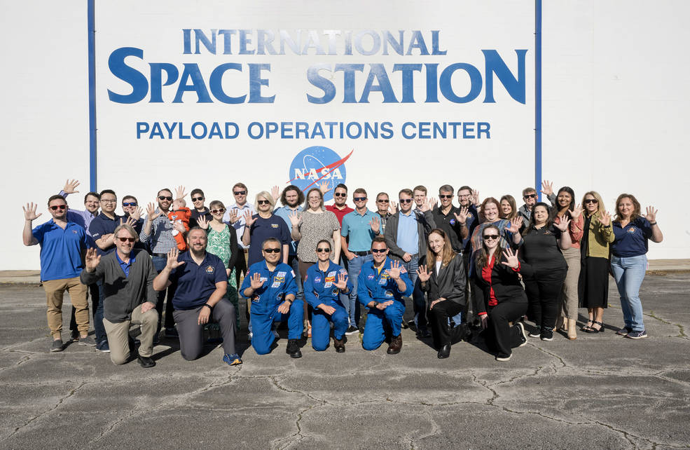 Marshall’s commercial crew support team posed with NASA’s SpaceX Crew-5 mission astronauts, holding up hands of five outside the Payload Operations Center in honor of the mission.
