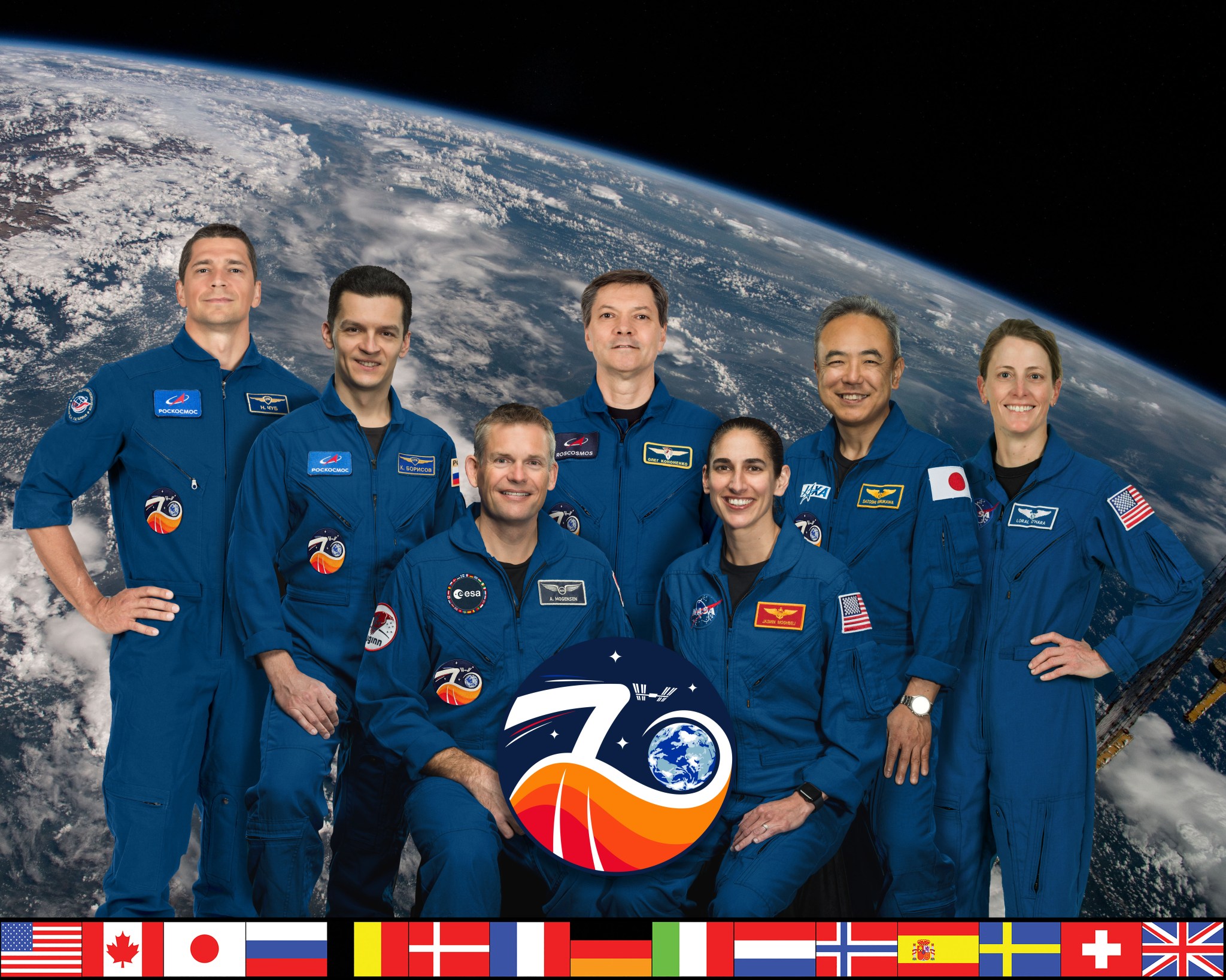 iss070-s-002 (March 6, 2023) --- The official Expedition 70 crew portrait with (top row from left) Roscosmos cosmonauts Nikolai Chub, Konstantin Borisov, and Oleg Kononenko; JAXA (Japan Aerospace Exploration Agency) astronaut Satoshi Furukawa; and NASA astronaut Loral O'Hara. In the front row are, ESA (European Space Agency) astronaut and Expedition 70 Commander Andreas Mogensen and NASA astronaut Jasmin Moghbeli.