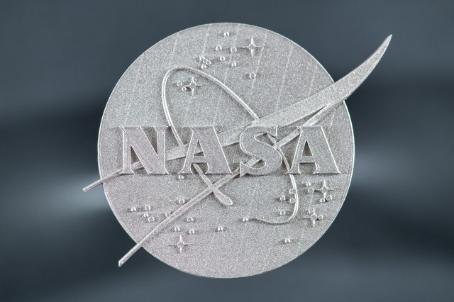 Smith and his team employed time-saving computer modeling, as well as a laser 3D printing process that fused metals together, layer-by-layer, to create the new alloy. They used this process to produce the NASA logo pictured above.
