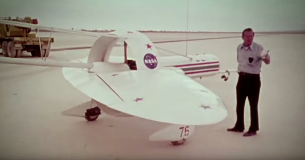 Screen shot from the video showing a man standing next to an X-Plane.