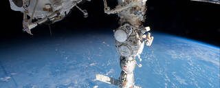 Cosmonauts work outside the space station to deploy and activate a radiator on the Nauka science module during a spacewalk on May 12, 2023.