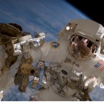 Astronaut Clay Anderson, Expedition 15 flight engineer, waves to the camera while participating in a session of extravehicular activity (EVA) as construction continues on the International Space Station. During the 7-hour 41-minute spacewalk, Anderson and cosmonaut Fyodor N. Yurchikhin (out of frame), commander representing Russia's Federal Space Agency, installed a television camera stanchion, reconfigured a power supply for an antenna assembly, and performed several get-ahead tasks. Also, while riding on the end of the Canadarm2, Anderson jettisoned the Early Ammonia Servicer (EAS) by shoving it opposite of the station's direction of travel. The station's robotic arm end effector is at left.