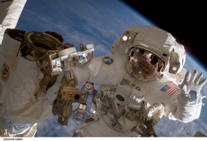 Astronaut Clay Anderson, Expedition 15 flight engineer, waves to the camera while participating in a session of extravehicular activity (EVA) as construction continues on the International Space Station. During the 7-hour 41-minute spacewalk, Anderson and cosmonaut Fyodor N. Yurchikhin (out of frame), commander representing Russia's Federal Space Agency, installed a television camera stanchion, reconfigured a power supply for an antenna assembly, and performed several get-ahead tasks. Also, while riding on the end of the Canadarm2, Anderson jettisoned the Early Ammonia Servicer (EAS) by shoving it opposite of the station's direction of travel. The station's robotic arm end effector is at left.