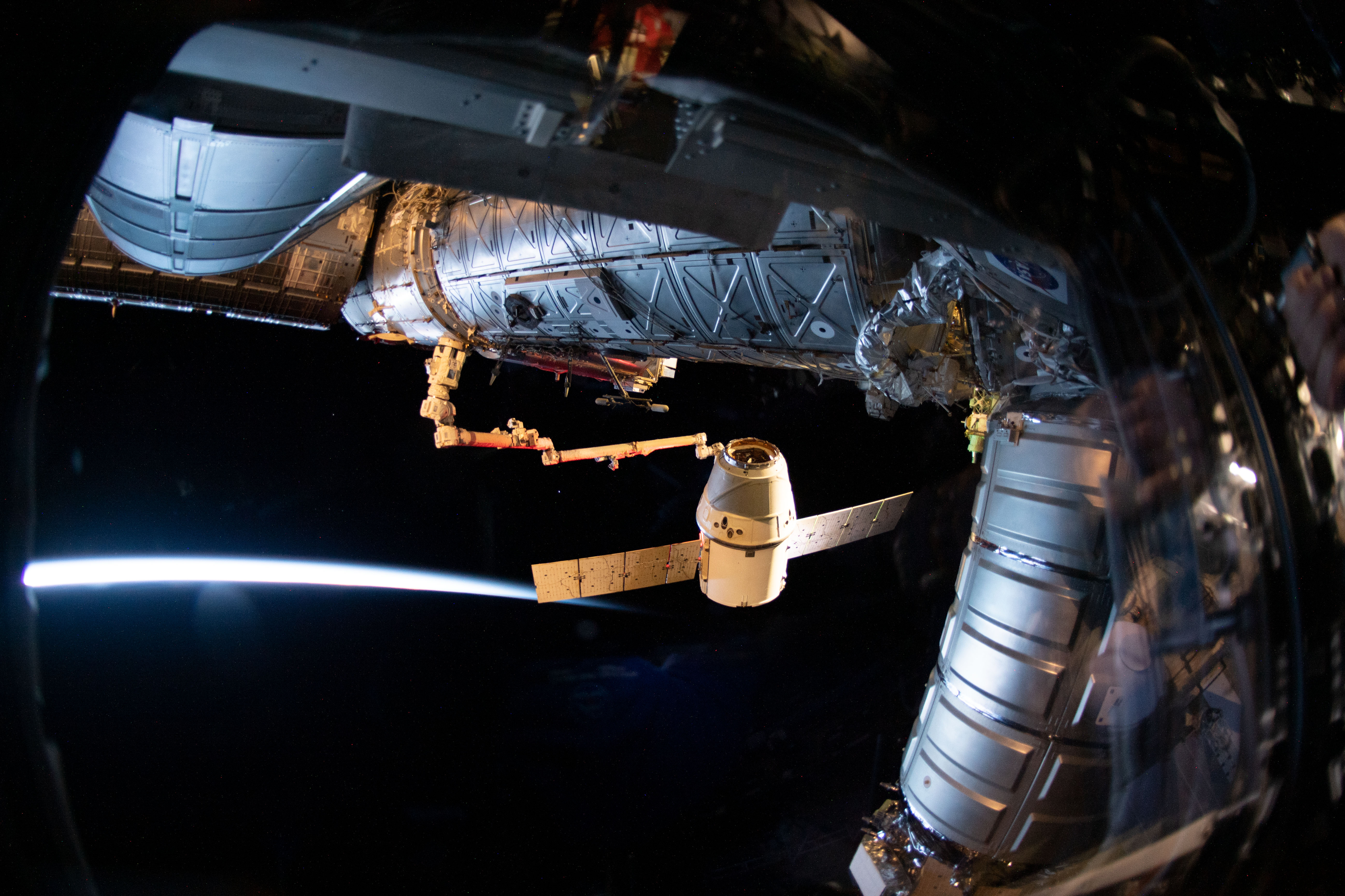 The SpaceX Dragon cargo craft on its 17th contracted mission to resupply mission to the International Space Station is pictured moments before being released from the Canadarm2 robotic arm.