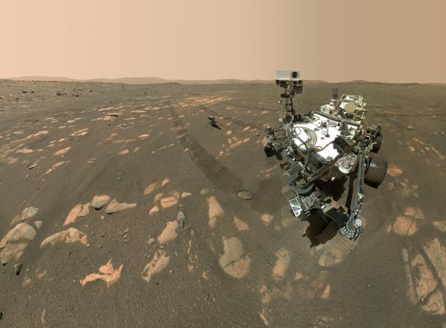 NASA's Perseverance Mars rover took a selfie with the Ingenuity helicopter, seen here about 13 feet (3.9 meters) from the rover. This image was taken by the WASTON camera on the rover's robotic arm on April 6, 2021.