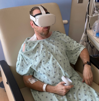 A patient experiencing balance issues wears video goggles for measuring head and eye movements. The dial he’s holding allows him to rate his levels of motion sickness as he tests out different head motions. A similar setup will be used on riders just after they exit the Kraken.