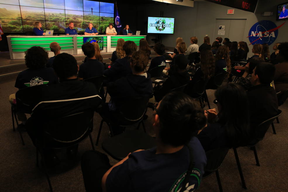 A mix of middle and high school students from schools in Florida and Georgia listen to a panel of environmental experts from NASA's Kennedy Space Center inside the John Holliman Auditorium of the News Center at the Florida spaceport on April 20, 2023.