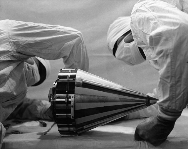 Technicians wearing clean-room attire inspect the Pioneer 3 probe before shipping it to Cape Canaveral, Fla.