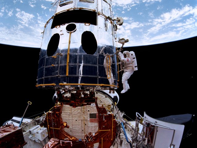 Astronauts from NASA's STS-61 crew install the Wide Field and Planetary Camera 2 on the Hubble Space Telescope
