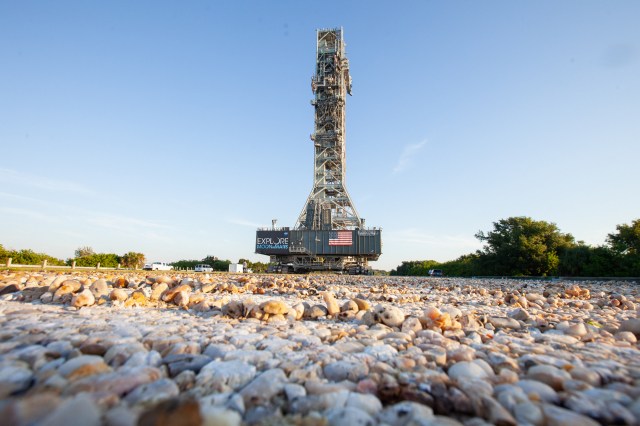 Exploration Ground Systems’ mobile launcher makes its solo trek along the crawlerway. Seen in the foreground is the river rock used to make up the crawlerway.