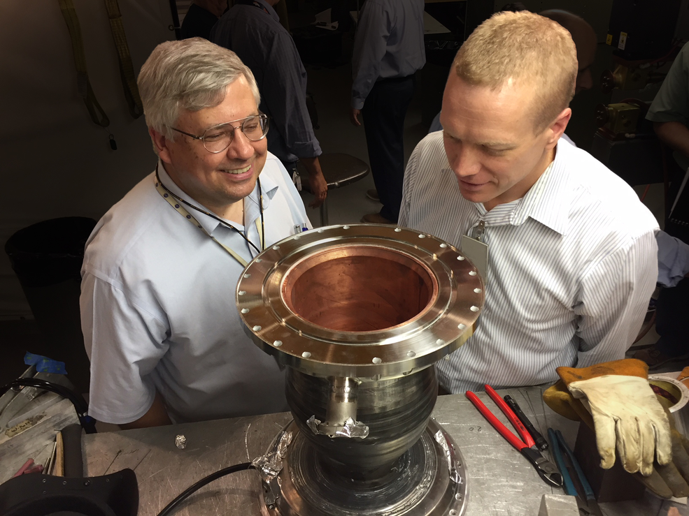 NASA materials engineers Dave Ellis and Chris Protz inspect the first additive manufactured GRCop combustion chamber. 