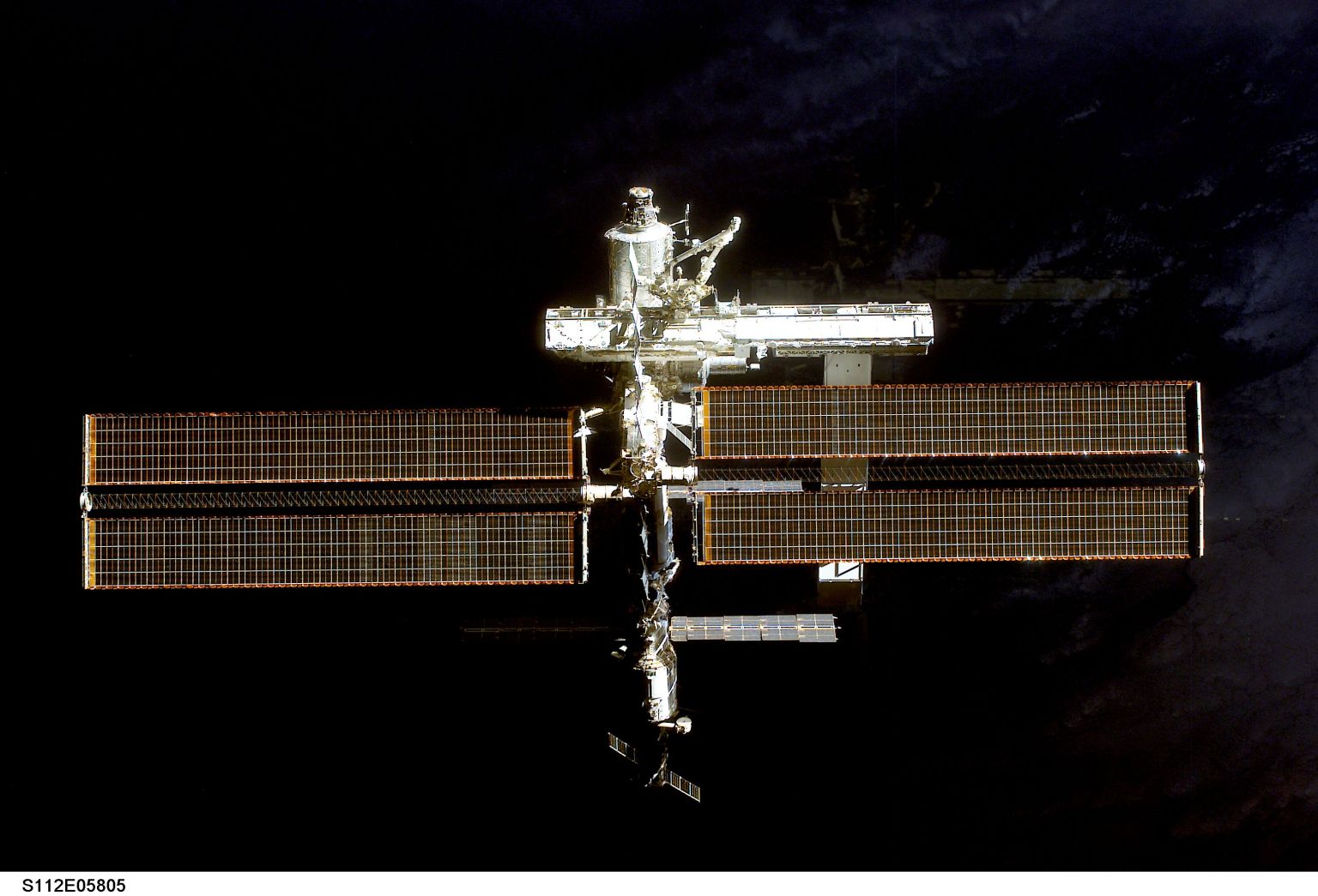 The new S1 (Starboard) truss is pictured extending from the S0 truss on the Unity module after space shuttle Atlantis undocked from the International Space Station on Oct. 16, 2002.