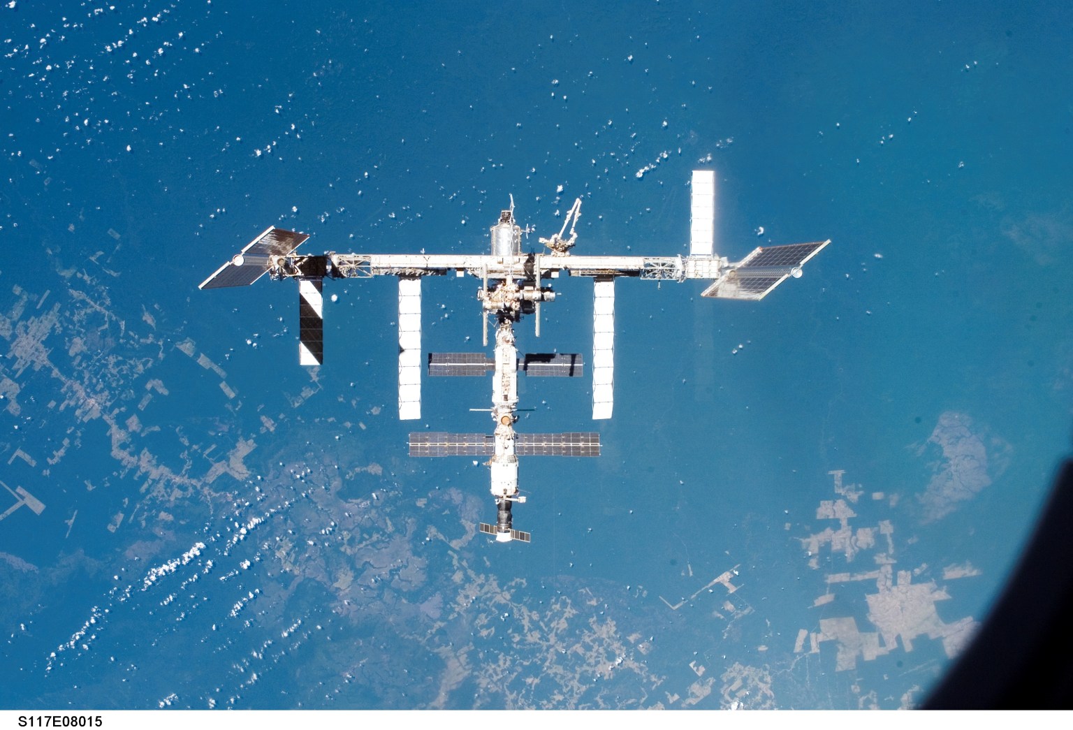 The S3/S4 (Starboard) truss segment adds to the expanding International Space Station's integrated truss segment in this photograph from space shuttle Atlantis after it undocked on June 19, 2007.