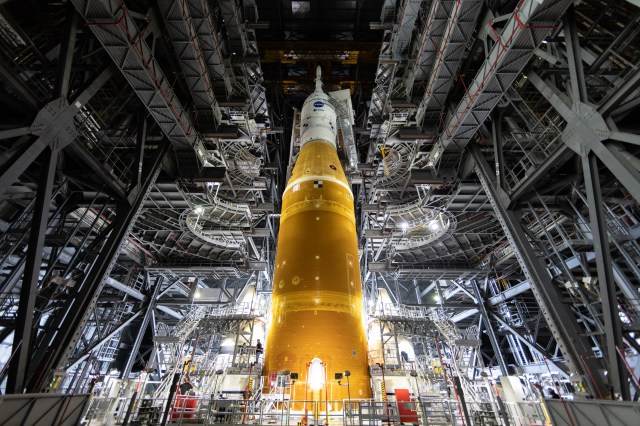 In this view looking up, the work platforms are being retracted from the Space Launch System rocket inside the Vehicle Assembly Building at NASA's Kennedy Space Center in Florida.