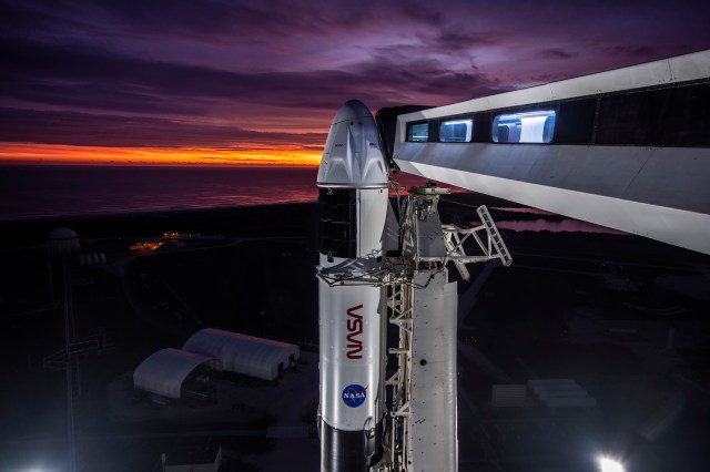 A close-up view of the SpaceX Falcon 9 rocket vertical with the Crew Dragon atop for the Crew-3 mission at Launch Pad 39A at NASA’s Kennedy Space Center in Florida during sunrise on Oct. 28, 2021. Also in view is the crew access arm. A four-person crew will launch aboard the Crew Dragon atop the Falcon 9 on Oct. 31 to the International Space Station. Launch is targeted for 2:21 a.m. EDT from Pad 39A. Crew 3 is the third crew rotation flight to the space station for NASA’s Commercial Crew Program, and the first flight of a new Crew Dragon spacecraft.