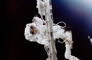 Astronaut Susan J. Helms works while holding onto a rigid umbilical and with her feet anchored to the remote manipulator system (RMS) robot arm on the Space Shuttle Discovery. This extravehicular activity (EVA), on which Helms was joined by astronaut James S. Voss (out of frame), was the first of two scheduled STS-102 space walks. The pair, destined to become members of the Expedition Two crew aboard the station later in the mission, rode aboard Discovery into orbit and at the time of this EVA were still regarded as STS-102 mission specialists.