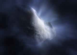 Illustration, close up of rocky body of a comet with detailed, cratered surface. Glowing rays emanate from the rocky surface like sunlight through clouds, representing water ice being vaporized by the heat of the Sun.