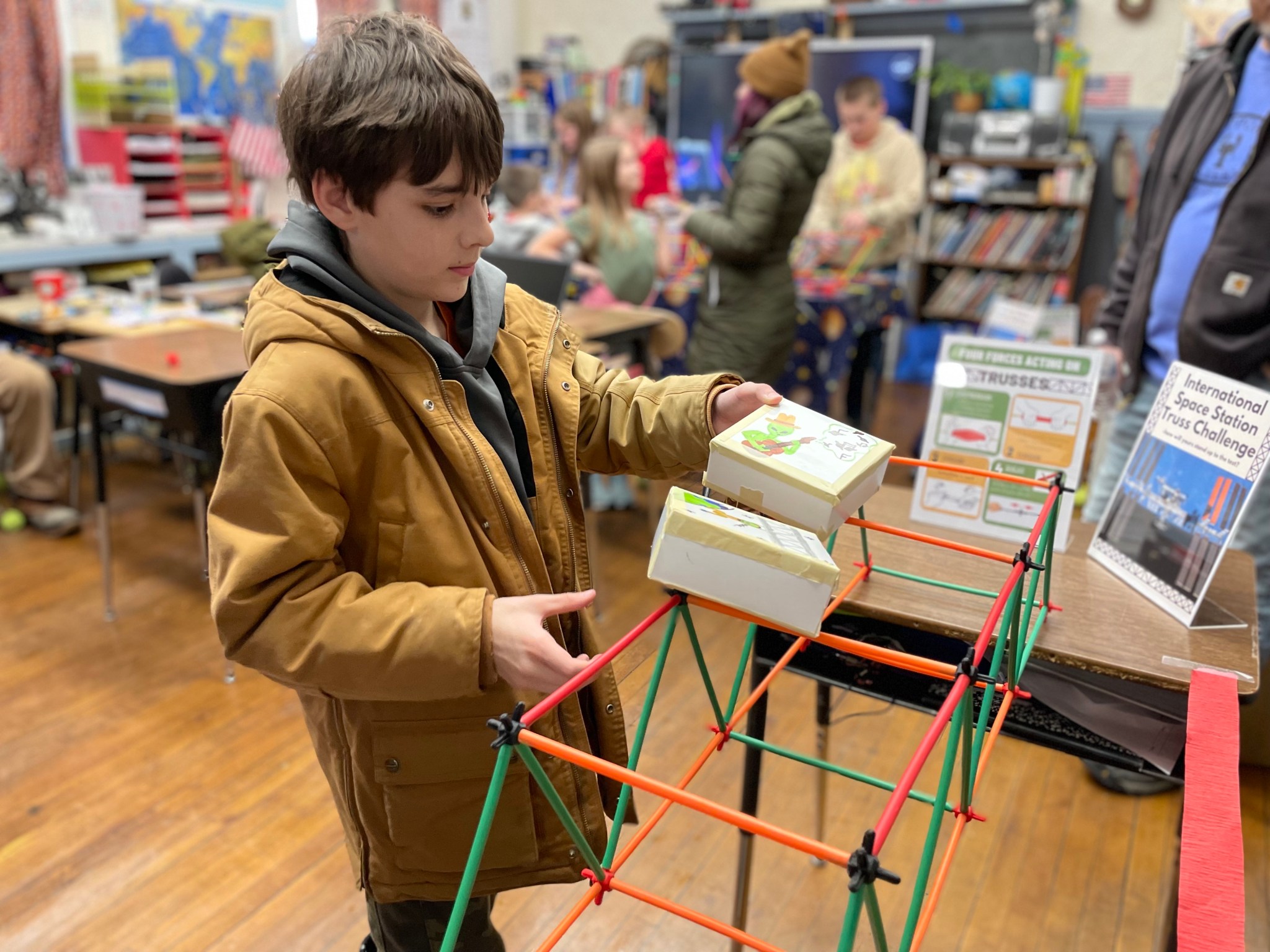 Cruz checks the load-bearing capability of his International Space Station-inspired truss structure during Moon to Mars STEM Community Night in Whiting, Maine, in February 2023.