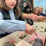 Students look at samples of lunar meteorites and rocks found on Earth, part of the Earth to Moon mobile exhibit developed by Saint Francis University in Loretto, Pennsylvania.