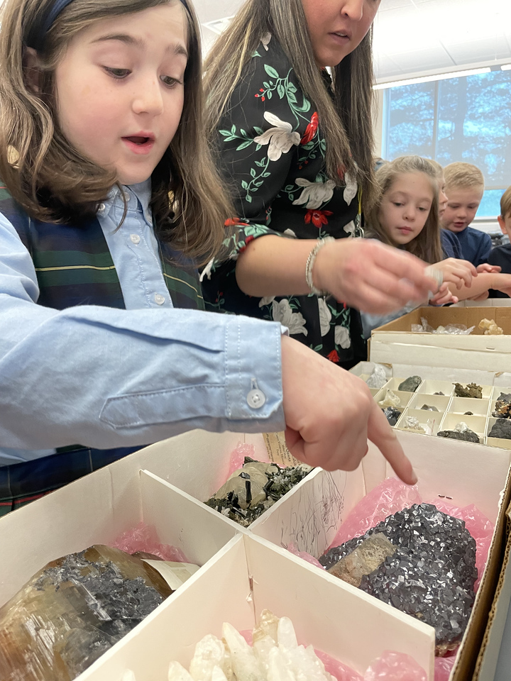 Students look at samples of lunar meteorites and rocks found on Earth, part of the Earth to Moon mobile exhibit developed by Saint Francis University in Loretto, Pennsylvania.