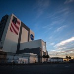 A view looking from the ground up at the Vehicle Assembly Building during sunrise at NASA's Kennedy Space Center in Florida.