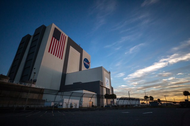 A view looking from the ground up at the Vehicle Assembly Building during sunrise at NASA's Kennedy Space Center in Florida.