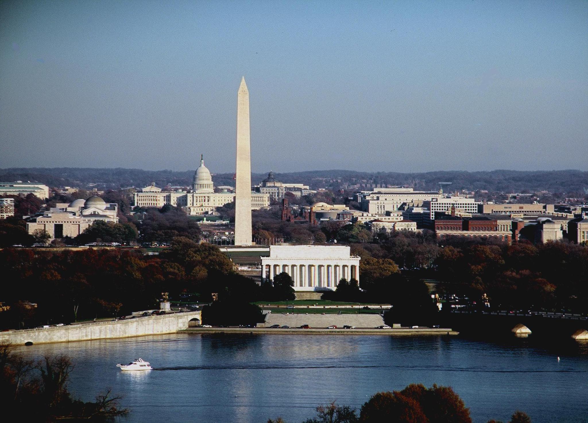 Photo of the Washington DC skyline from the Potomac River. In the foreground is the Lincoln Memorial, followed by the Washington Monument, and the U.S. Capitol Building in the very back.