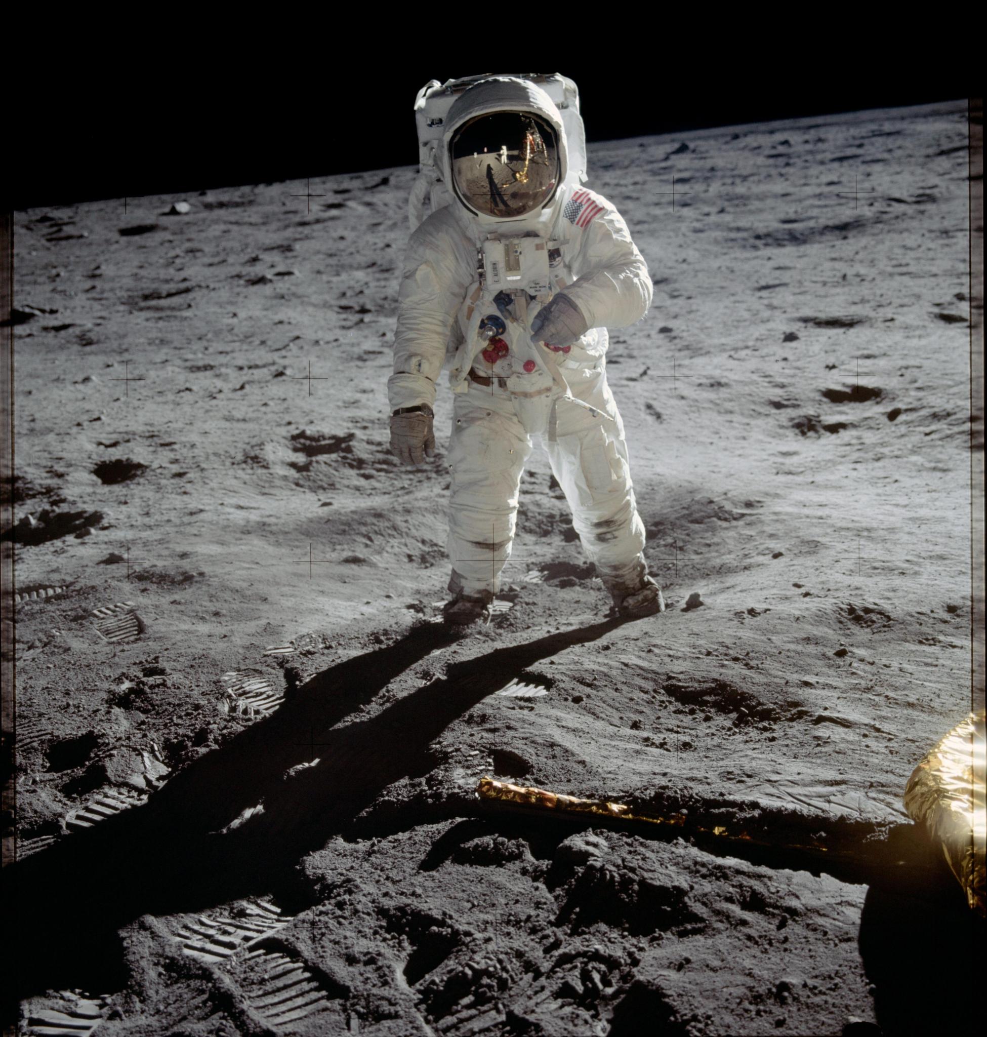Astronaut Buzz Aldrin walks on the surface of the Moon near the leg of the lunar module Eagle during the Apollo 11 mission.
