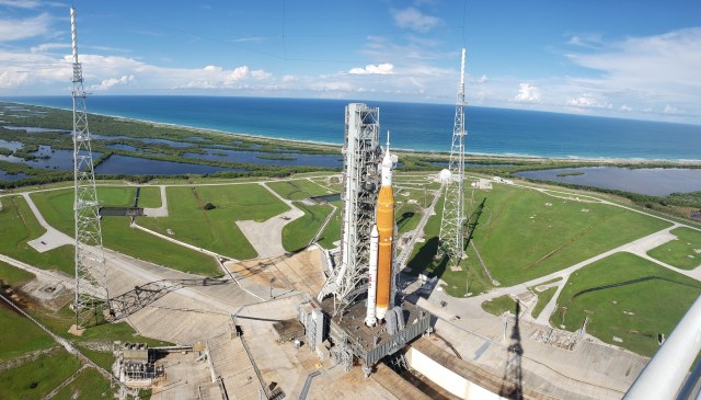 A view of the Artemis I Space Launch System (SLS) and Orion spacecraft atop the mobile launcher on Launch Pad 39B at NASA’s Kennedy Space Center in Florida on Sept. 15, 2022. Also in view are two of the three lightning towers that surround the pad and protect the SLS and Orion from lightning strikes.
