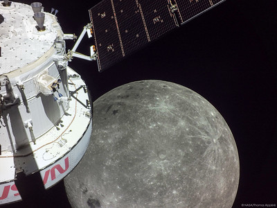 A portion of the far side of the Moon looms large just beyond the Orion spacecraft in this image taken on the sixth day of the Artemis I mission by a camera on the tip of one of Orion’s solar arrays.