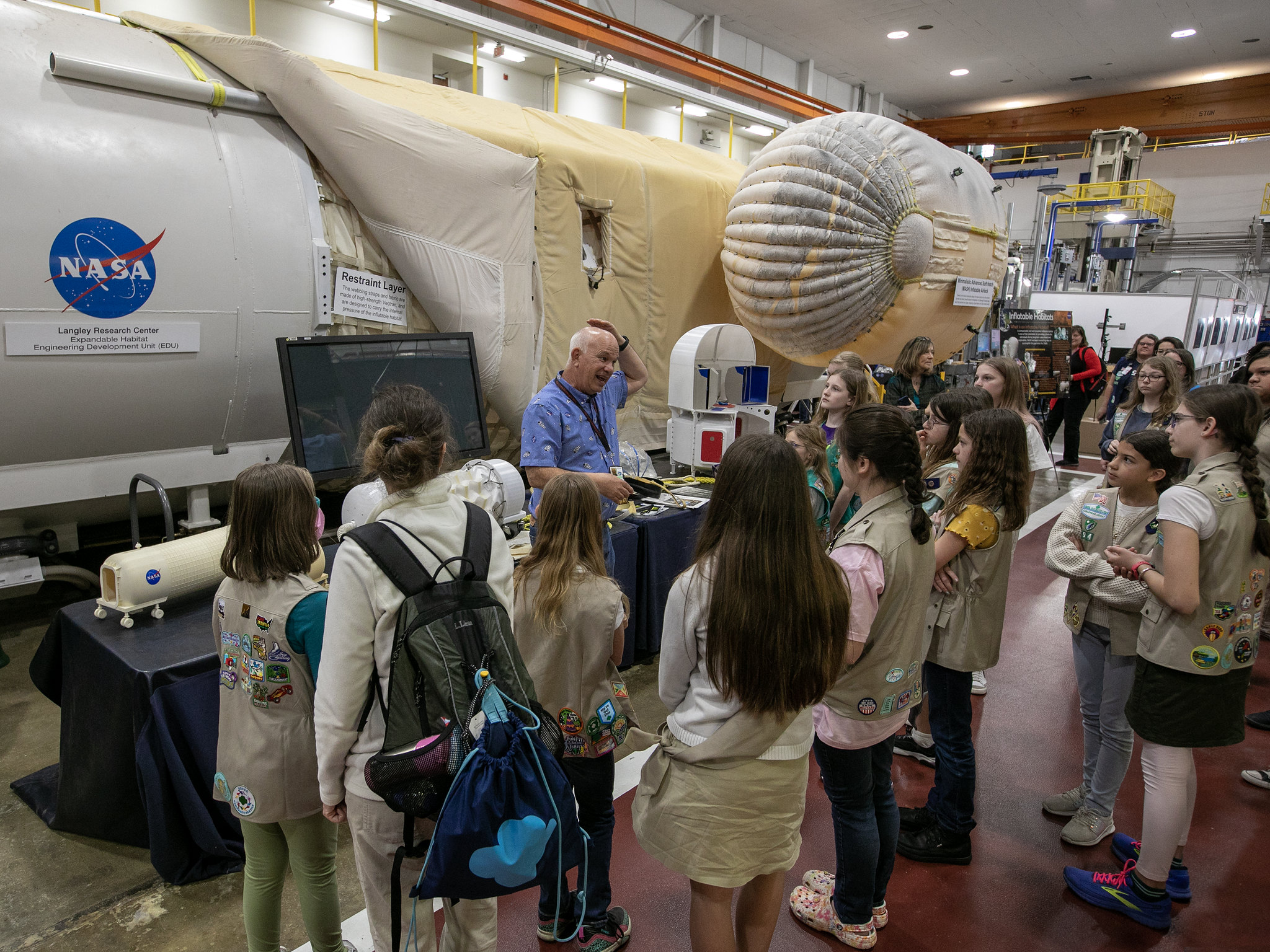 A group of girl scouts listens to a NASA Langley researcher during a tour of the center.